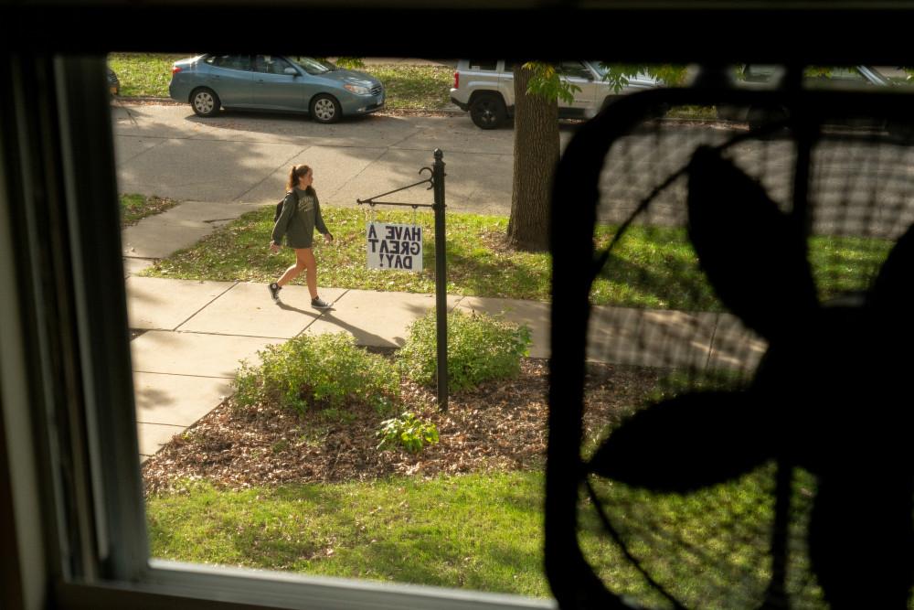 The view out of a student's dorm room window, looking at a sign reading, have a great day.
